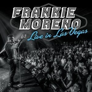 A man on stage sings into a microphone, facing a large audience, with "FRANKIE MORENO Live in Las Vegas" above.