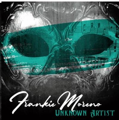 Unknown Artist 2022 A black and white masquerade mask with a teal band across the eyes, featuring musical notes and text "Frankie Moreno UNKNOWN ARTIST".