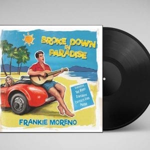 A vinyl record and album cover with a cartoon man playing guitar on a red car, titled "Broke Down in Paradise."