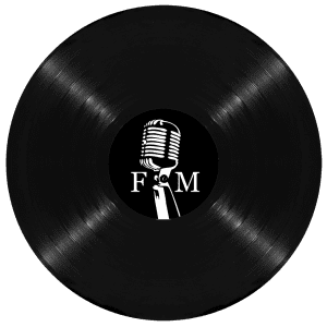 A black vinyl record with a label featuring a white vintage microphone and the letters "F" and "M".