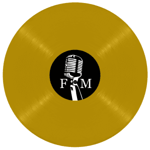 A gold vinyl record with a black label featuring a white vintage microphone and the letters "F" and "M".