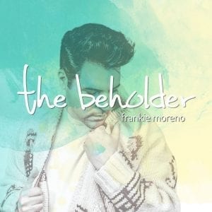 A man in a patterned sweater looks down, with "the beholder" and "frankie moreno" in white text.