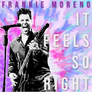 Frankie Moreno sings into a microphone, playing a guitar against a tie-dye background with "IT FEELS SO RIGHT."