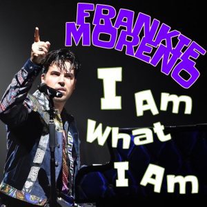 Frankie Moreno, wearing a patterned jacket, sings into a microphone with his finger pointed up. Text reads "FRANKIE MORENO I Am What I Am".