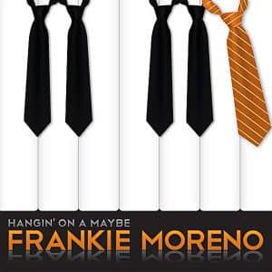 Four black ties and one orange striped tie hang over white piano keys with "FRANKIE MORENO" text.