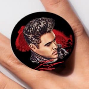 A black circular pop socket with an illustration of Elvis Presley's head and shoulders, "Elvis" in red.